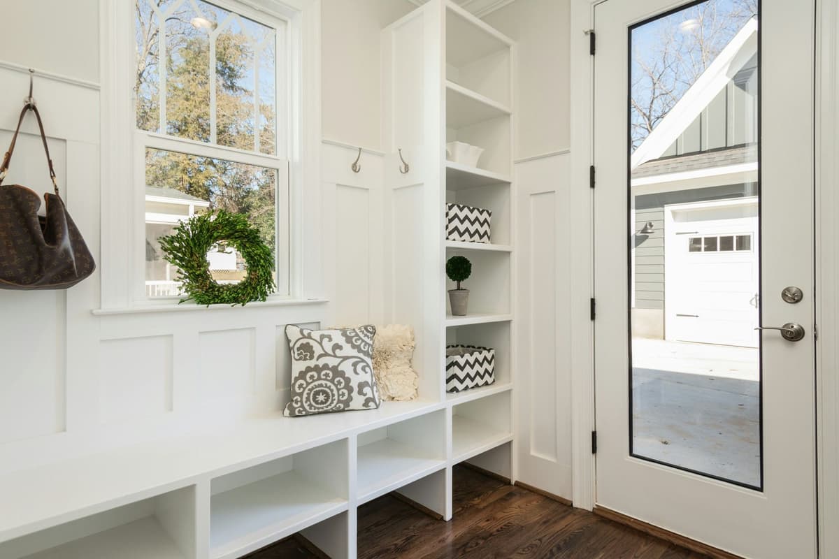 Custom-painted mudroom with built-in bench, cubbies, and board-and-batten wainscoting