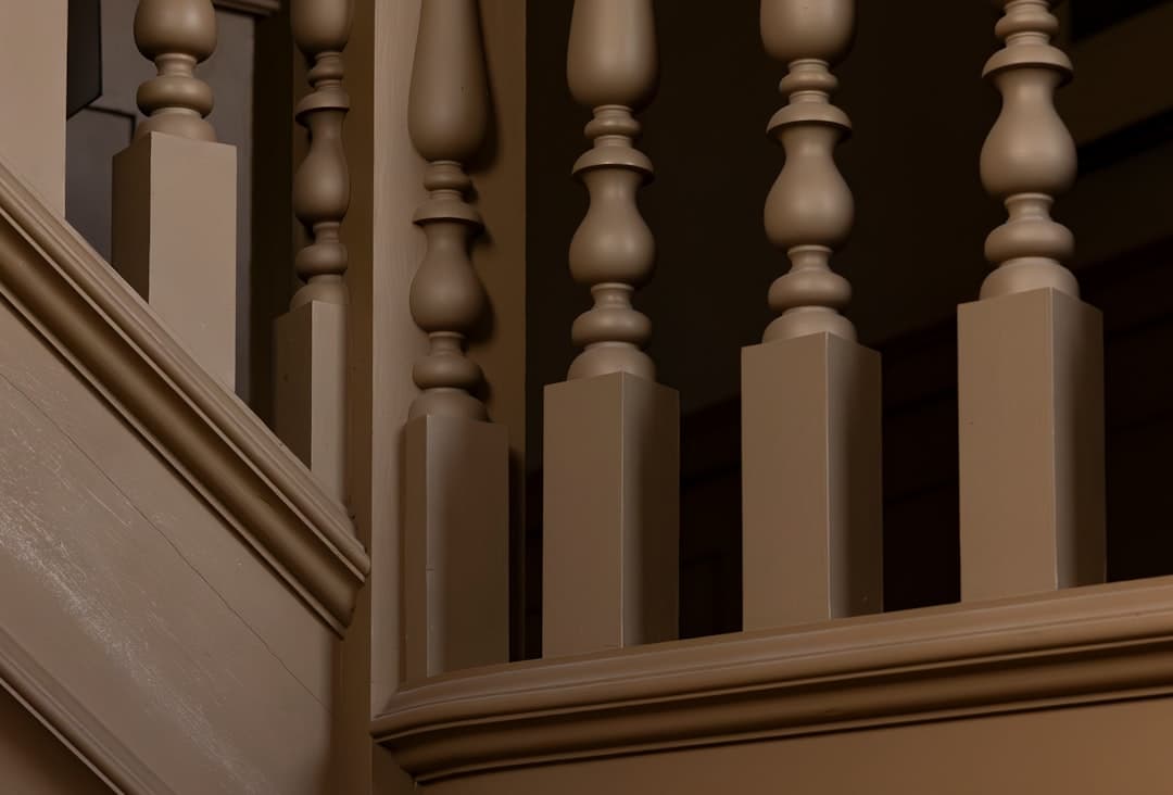 Interior staircase with hand-stained wood banisters and trim detail