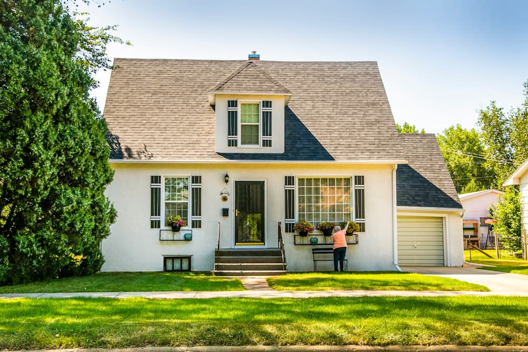 Pristine white home exterior with immaculate surfaces and manicured landscaping