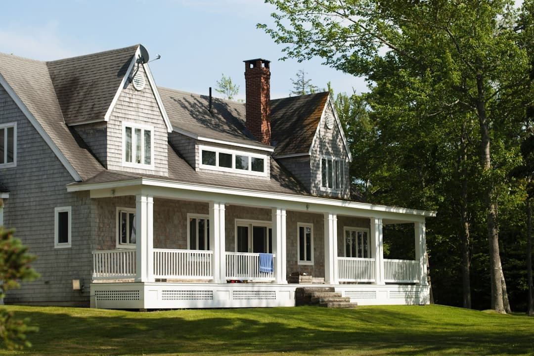 Classic shingle-style home exterior with crisp white trim and lush landscaping